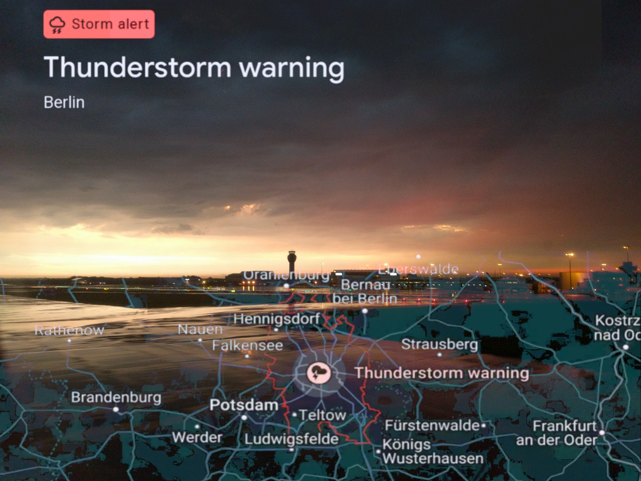 Google thunderstorm weather alert with map of Berlin and airport in background